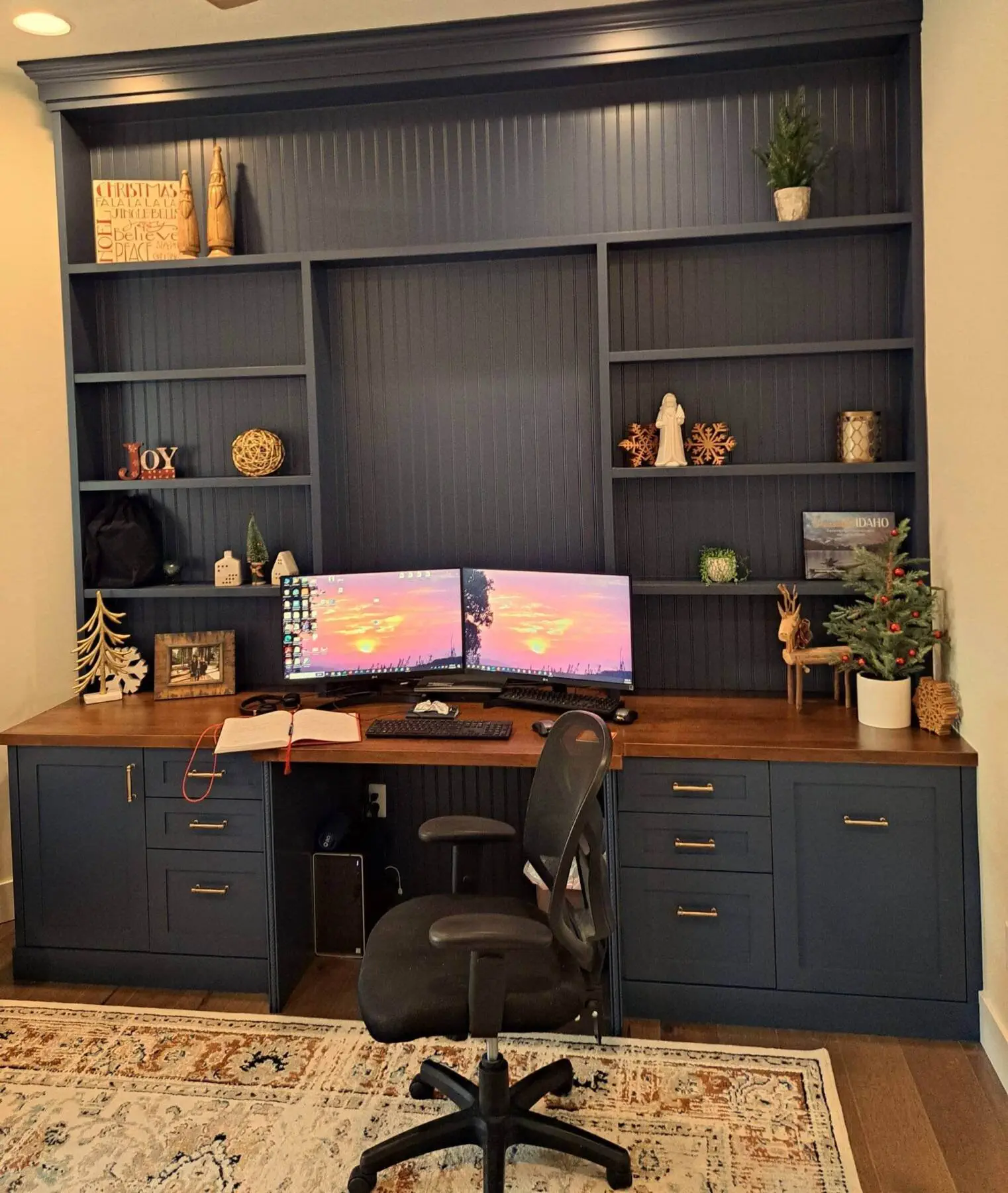 a desk with a computer and shelves in a room