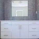 a bathroom with a mirror above the sink